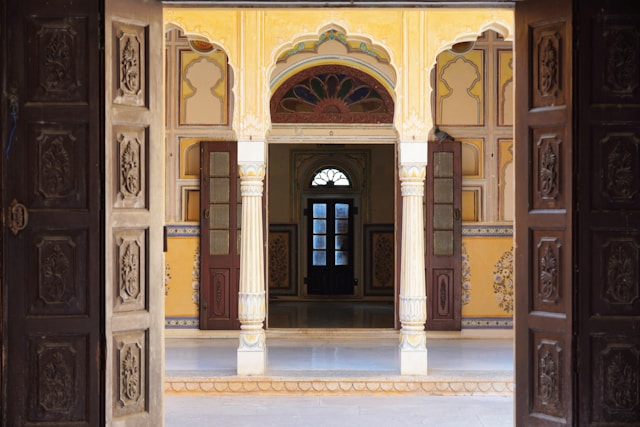 Ornate doorway leading into a yellow courtyard