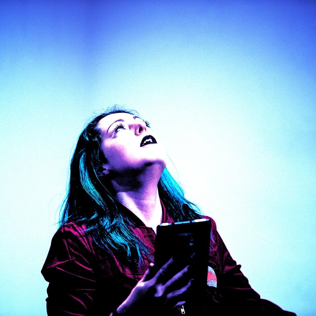 Photo of L. Nicol Cabe looking up in a blue light
