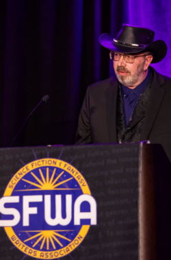 SFWA Operations Director Russell Davis introduces Gay Haldeman, recipient of the Kevin O'Donnell, Jr. Service to SFWA Award in Chicago, June 2026